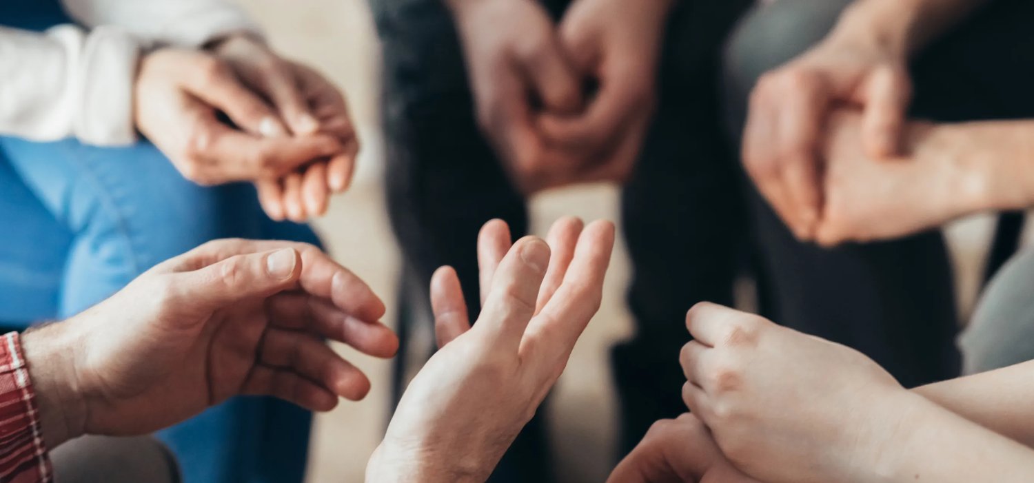 close-up-of-hands-of-people-sitting-in-a-circle-du-2021-08-27-16-16-40-utc 1