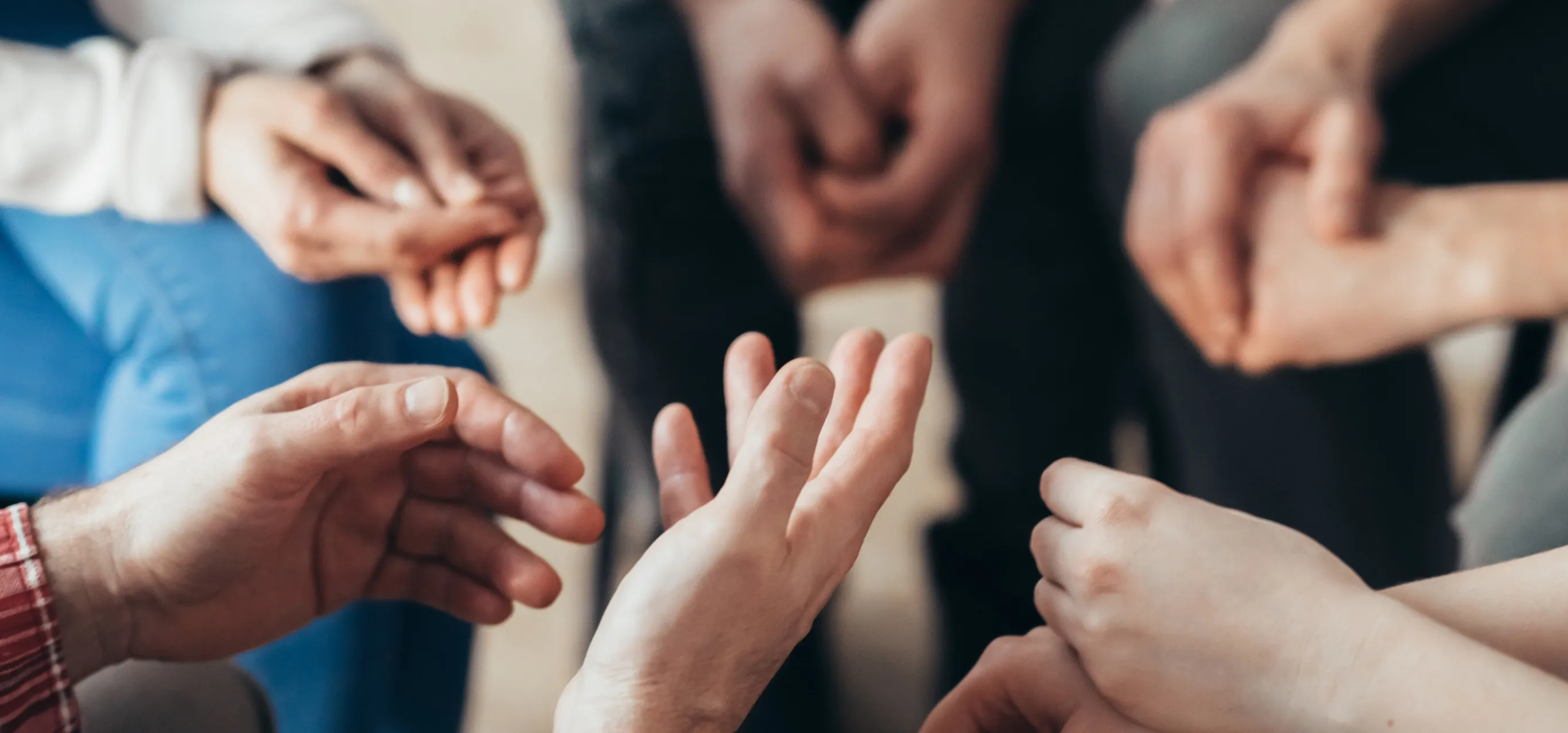 close-up-of-hands-of-people-sitting-in-a-circle-du-2021-08-27-16-16-40-utc 1